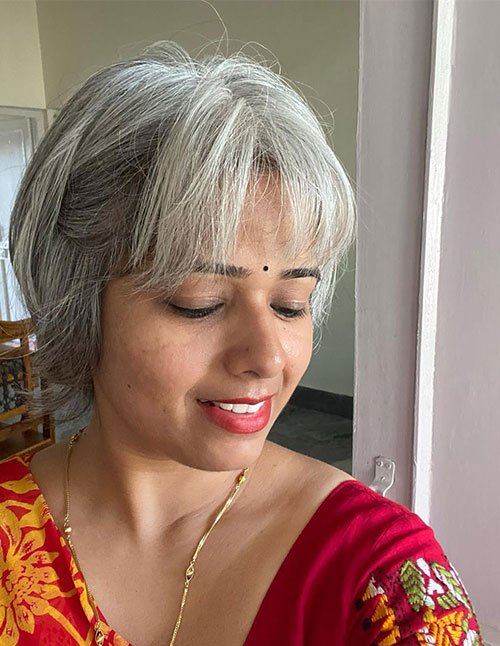 Layered bob with wispy bangs and soft feathered ends