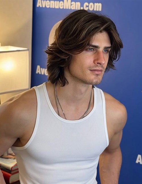 Man with layered straight medium-length hair, featuring soft volume and face-framing layers.
