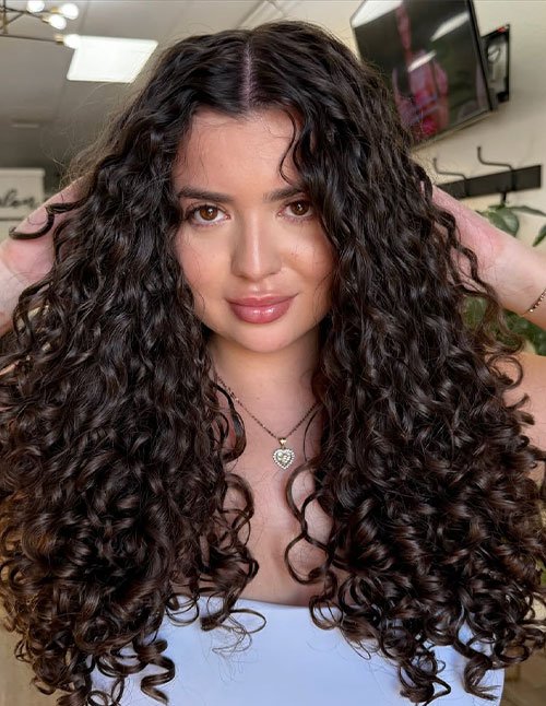 Long layered glam curls with middle part and defined ringlets