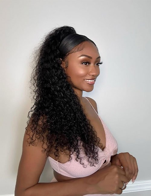 Loose curly high ponytail with sleek sides and voluminous curls
