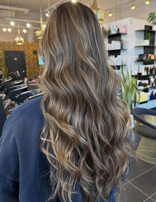 Loose waves flowing through medium-to-long hair, creating soft S-shaped texture and natural movement.