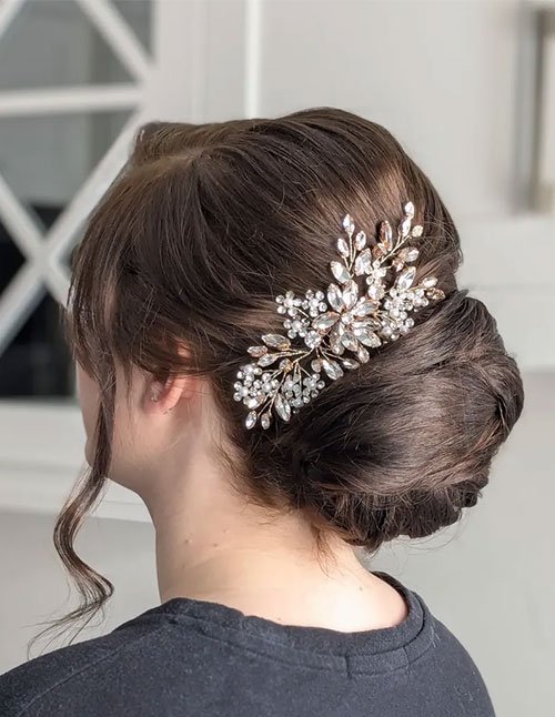 Low twist updo on fine hair with a smooth side part and a sparkling floral hair comb, side view.