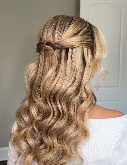Medium Short Glam half-up style with a twisted back section and soft, blonde waves.