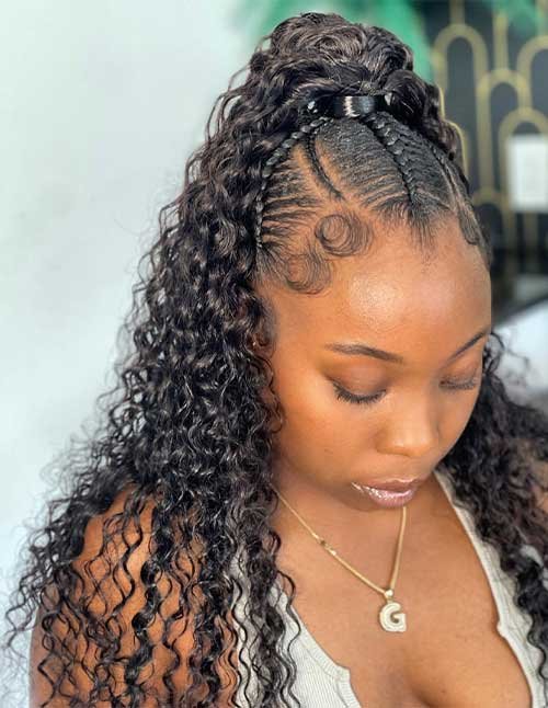 Pretty half-up braided hairstyle with two sleek cornrows leading into a high ponytail of defined curly hair, finished with laid baby hairs.