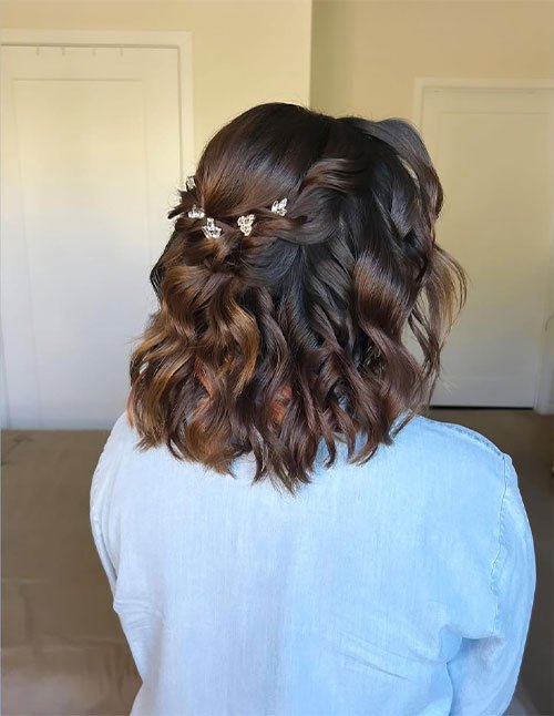 Half-up twist on short wavy hair with small crystal pins, shown from the back.