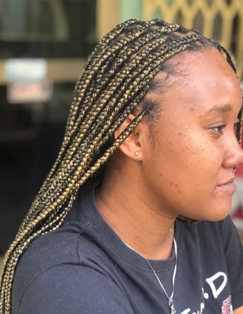 Quick golden braids look with medium box braids in a dark-to-honey blonde blend, styled sleek and laid back from the hairline.