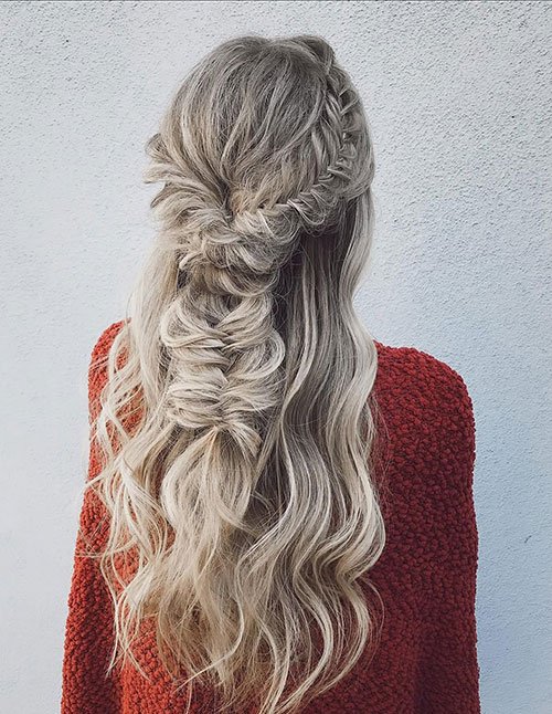 Loose half-up braid with soft waves flowing down the back.