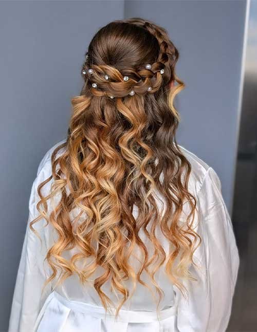 Royal crown braid hairstyle with soft waves and pearl hair pins.