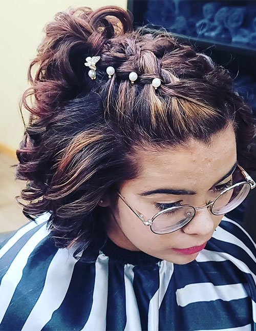 Short hair homecoming style with a braided half-up section and pearl hair pins.