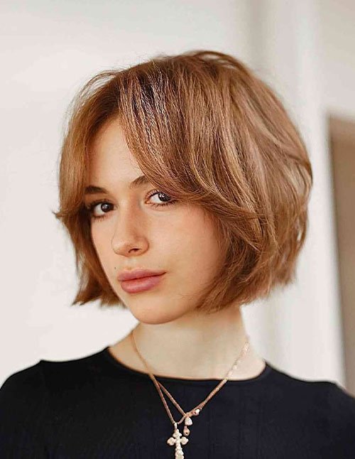 Short Layered Bob with side-parted volume and soft feathered ends