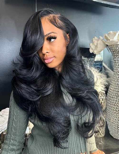 Girl with long, glossy hair styled in a deep side part with big soft curls and a side-swept front section.