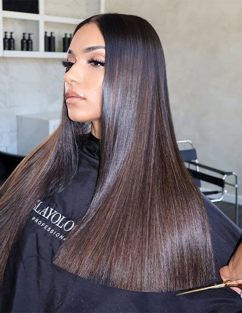Sleek straight hair with a sharp center part and smooth, glossy finish.