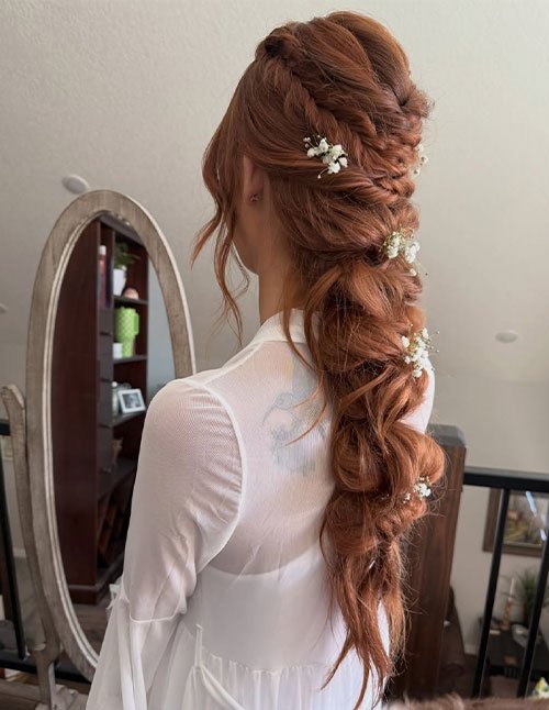 Romantic bridal bubble braid on red hair with baby’s breath flowers, back view.