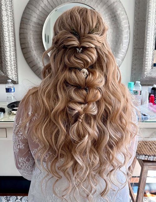 Soft half-up bubble braid on long wavy-curly hair with delicate hair pins