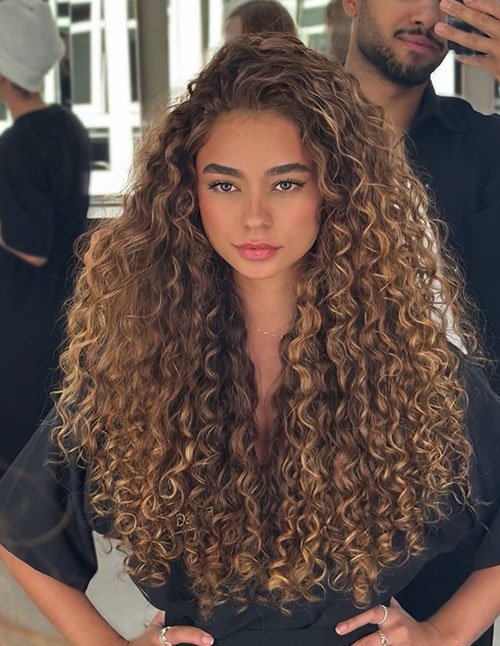 Voluminous curly blowout with long defined curls and salon-finish shine