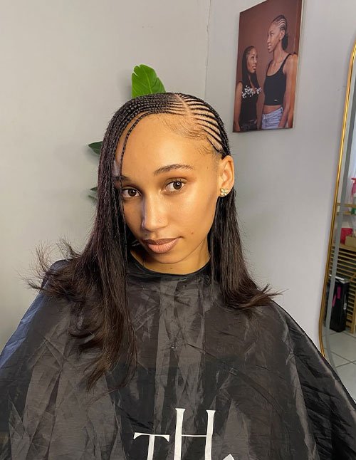 Tyla-inspired braided hairstyle with sleek side cornrows blended into straight, shoulder-length hair.