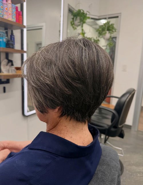Back view of Wispy Bob Haircut with soft layers and natural gray hair