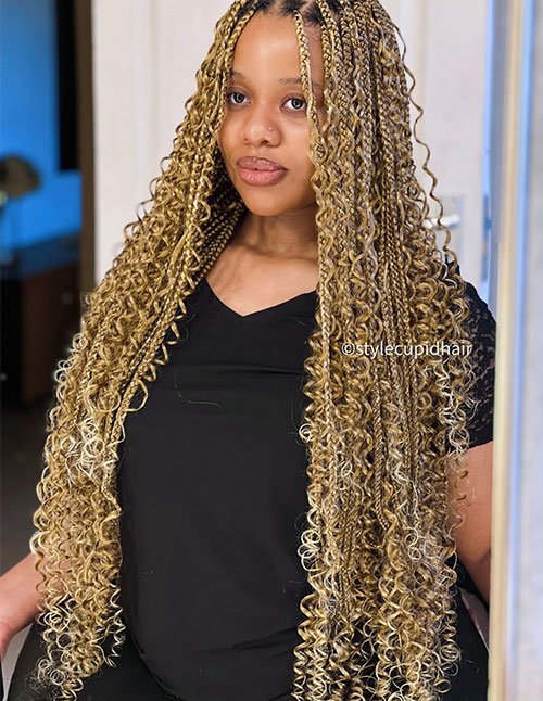 Long blonde goddess braids with loose curls and a middle part